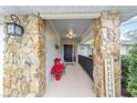 Inviting entryway with stone columns and a charming bench at 5041 County Road 114, Wildwood, FL 34785