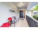 Covered entryway with stone accents and a welcoming bench at 5041 County Road 114, Wildwood, FL 34785