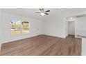 Bright and airy living room with hardwood floors and access to kitchen at 53 Guava Pl, Ocklawaha, FL 32179