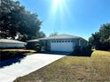 Gray house with white garage door and American flag, set back from the road at 6082 Sw 104Th St, Ocala, FL 34476