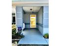 Welcoming covered front porch with a storm door and decorative concrete columns at 6082 Sw 104Th St, Ocala, FL 34476