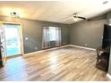 Bright living room with gray walls, wood-look floors, and a yellow door at 6082 Sw 104Th St, Ocala, FL 34476