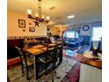 Bright dining room with a rustic wooden table and chandelier at 6180 Sw 110Th St, Ocala, FL 34476