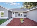 Landscaped front yard with walkway leading to front door at 66 Teak Loop, Ocala, FL 34472