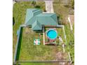 Aerial view showing house, fenced backyard, pool, and deck at 73 Bahia Trace Crse, Ocala, FL 34472