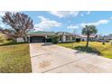 Tan house with green roof and attached garage at 73 Bahia Trace Crse, Ocala, FL 34472