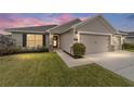 Two-story house exterior with a two-car garage at dusk at 8405 Sw 59Th Ter, Ocala, FL 34476