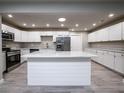 Modern kitchen with white cabinets, stainless steel appliances, and an island at 8626 Sw 97Th Lane Rd # D, Ocala, FL 34481