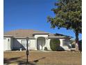 House exterior showcasing a well-maintained lawn and front entrance at 8697 Se 136Th Ln, Summerfield, FL 34491