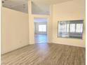 Bright living room featuring wood-look floors and views into other rooms at 8697 Se 136Th Ln, Summerfield, FL 34491