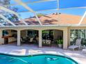 Screened patio with pool, outdoor kitchen, lounge chairs, and dining area at 8990 Se 178Th Muirfield Pl, The Villages, FL 32162