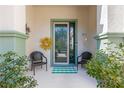 Front porch with seating area and green door at 9470 Sw 66Th Loop, Ocala, FL 34481