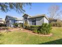 One story home with side yard view, lush landscaping and walkway at 9554 Sw 93Rd Loop, Ocala, FL 34481