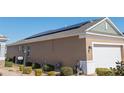 Home with solar panels and a two-car garage at 9945 Sw 100Th Terrace Rd, Ocala, FL 34481