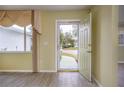 Open door revealing a view of a walkway and front yard at 10882 Sw 62Nd Ave, Ocala, FL 34476