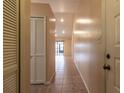 Tiled entryway with built-in closet and view to living room at 10918 Se 50 Ave, Belleview, FL 34420