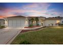 Attractive home with well-manicured lawn at dusk at 13560 Se 90Th Ct, Summerfield, FL 34491