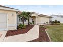 Landscaped walkway leading to the entrance of the home at 13560 Se 90Th Ct, Summerfield, FL 34491