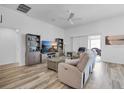 Bright living room featuring hardwood floors and a comfy seating area at 1789 Usrey Ct, Okahumpka, FL 34762