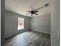 Bright bedroom with vinyl plank flooring and a large window at 20653 Sw Audubon Ave, Dunnellon, FL 34431