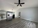 Spacious living room featuring a ceiling fan and vinyl plank flooring at 20653 Sw Audubon Ave, Dunnellon, FL 34431