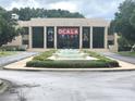 Exterior view of the Appleton Museum featuring a modern facade and a tranquil water feature in front at 2154 Nw 23Rd Loop, Ocala, FL 34475
