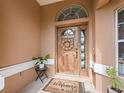 Front door with welcome mat and wreath at 22287 Sw Mango Ln, Dunnellon, FL 34431