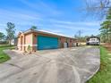 Attached garage with teal door and RV parking at 22287 Sw Mango Ln, Dunnellon, FL 34431