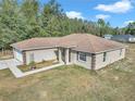 One-story house with brown roof and light beige siding at 3 Locust Trak, Ocala, FL 34472