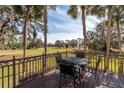 Dark metal patio furniture sits on this wooden deck overlooking a lush green lawn at 4343 Nw 80Th Ave # 8, Ocala, FL 34482