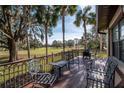 A charming deck area offering a scenic view of a lush green space and mature trees at 4343 Nw 80Th Ave # 8, Ocala, FL 34482