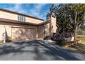 Exterior view of the home's side, showing the garage, a chimney, and an exterior deck area at 4343 Nw 80Th Ave # 8, Ocala, FL 34482