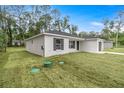 View of home's side, highlighting gray shutters and white exterior at 6068 Nw 57Th Ave, Ocala, FL 34482