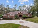 Brick home with double doors and landscaping at 7267 Se 12Th Cir, Ocala, FL 34480