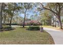 Brick home nestled among mature trees, circular driveway at 7267 Se 12Th Cir, Ocala, FL 34480