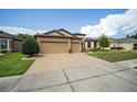 Two-story house with a three-car garage and nicely landscaped lawn at 7646 Sw 100Th Ct, Ocala, FL 34481