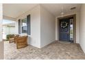 Inviting front porch with wicker chairs and a view of the street at 7977 Sw 85Th Loop, Ocala, FL 34476