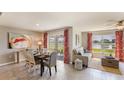 Bright dining area with sliding glass doors leading to a patio and water views at 8503 Las Palmas Way, Wildwood, FL 34785