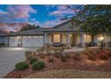 Attractive home at dusk with a 3-car garage and well-manicured landscaping at 8749 Sw 93Rd Cir, Ocala, FL 34481