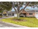 Charming villa with a tree-lined street and well-maintained landscaping at 9051 Sw 96Th Ln # B, Ocala, FL 34481