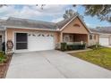 Well-maintained home with a manicured lawn, a paved driveway, and an attached garage at 9051 Sw 96Th Ln # B, Ocala, FL 34481