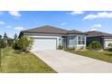 Front view of a one-story house with a garage and landscaping at 9411 Sw 54Th St, Ocala, FL 34481