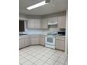 Kitchen features white appliances and ample counter space at 9794 Sw 96Th St, Ocala, FL 34481