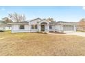 Newly constructed home with gray exterior, and landscaping at 10628 Sw 74Th Ave, Ocala, FL 34476