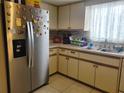 Stainless steel refrigerator and white cabinetry in this kitchen at 10800 Sw 62Nd Ave, Ocala, FL 34476