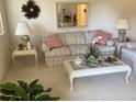 Living room featuring a striped sofa and a glass-top coffee table at 10829 Sw 83Rd Ave, Ocala, FL 34481