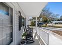 Relaxing front porch with rocking chairs and street view at 11253 Sw 77Th Ct, Ocala, FL 34476