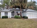 One-story home with palm trees and attached garage at 11577 Sw 72Nd Cir, Ocala, FL 34476