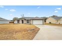 Newly built home with a 1-car garage and driveway at 12 Pine Trace Pl, Ocala, FL 34472