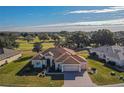 Single-story home with golf course views and a two-car garage at 12955 Se 93Rd Cir, Summerfield, FL 34491